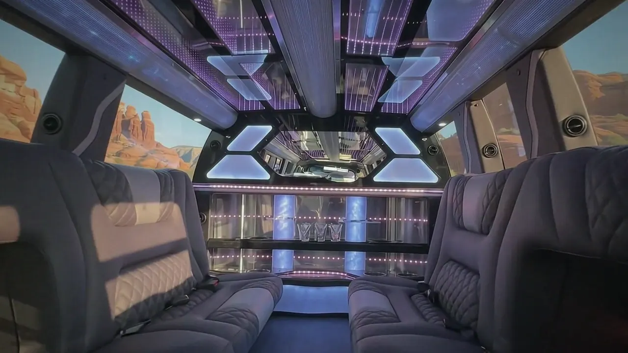 Inside the Cadillac Escalade limo in Arvada: LED light-show ceiling, leather lounge seating and lit bar